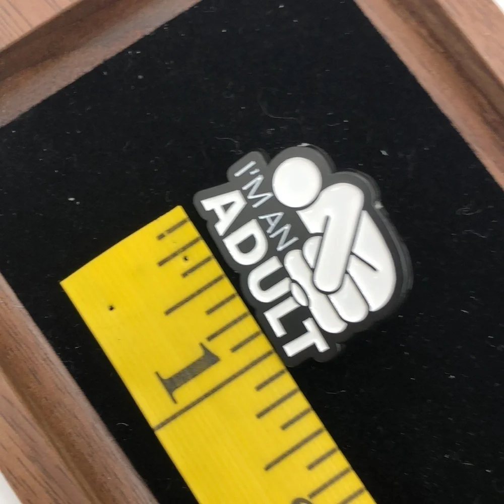3/$25 “I’m An Adult” with the adult laying in the fetal position. Unisex pin